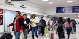 Passengers walk through a terminal at Mexico City International Airport