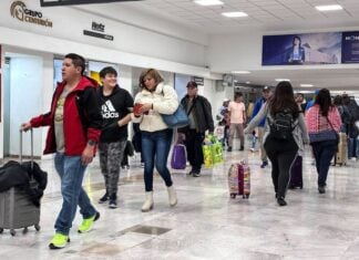 Passengers walk through a terminal at Mexico City International Airport