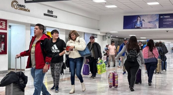Passengers walk through a terminal at Mexico City International Airport