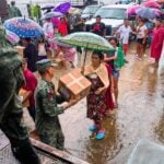 Mexican soldiers hand out supplies in the wake of Hurricane John