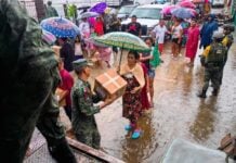 Mexican soldiers hand out supplies in the wake of Hurricane John