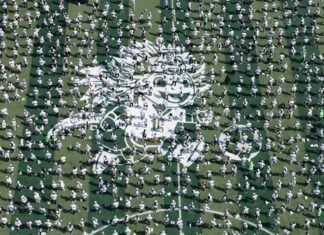 an aerial shot of hundreds of soccer players on an artificial turf set up in Mexico City's Zócalo