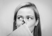 A woman holding her nose