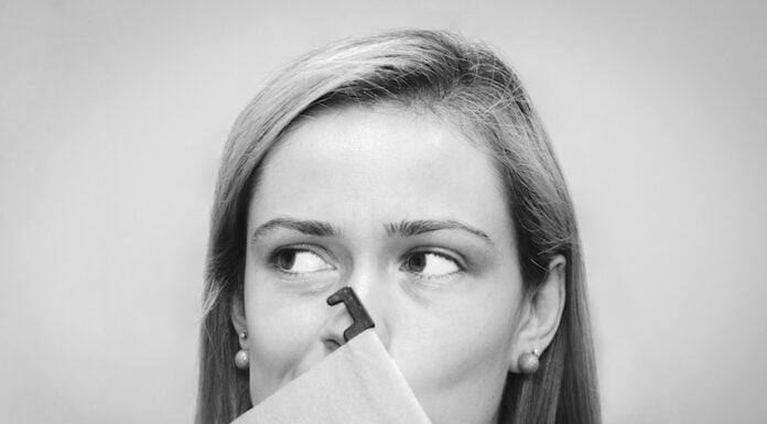 A woman holding her nose