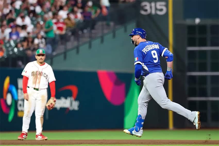 Vinnie Pasquantino, Italy No. 9, runs past a Mexican baseball outfielder