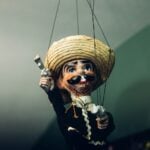 A Mexican puppet with a gun