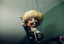A Mexican puppet with a gun