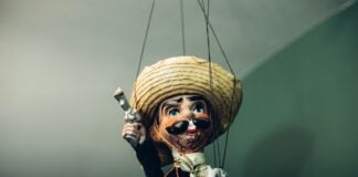 A Mexican puppet with a gun