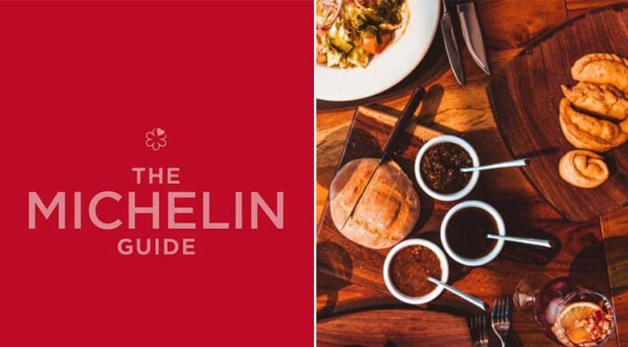 An image of the Michelin Guide logo next to a spread of food on a restaurant table