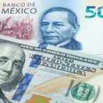 A 100-US dollar bill and a 500-Mexican peso bill