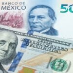 500 Mexican peso and US 100 dollar banknotes. International trade concept