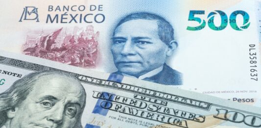 500 Mexican peso and US 100 dollar banknotes. International trade concept
