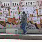 A man walks by a wall of posters of missing people in Mexico City