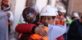 The father of Jose Ángel Hernandez Vélez, one of 9 miners who had gone missing and were later found dead in a clandestine grave, receives a hug from a fellow miner during a march for justice in Zacatecas in February.