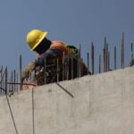 Mexican construction worker on a wall