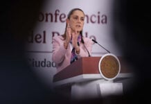 President Sheinbaum gestures from the podium of her morning press conference