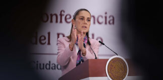 President Sheinbaum gestures from the podium of her morning press conference