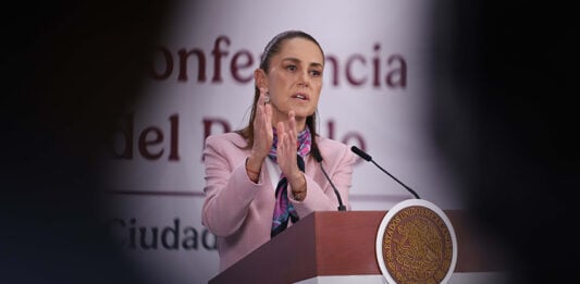 President Sheinbaum gestures from the podium of her morning press conference