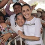 President Sheinbaum hugs a constituent at a packed rally