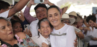 President Sheinbaum hugs a constituent at a packed rally