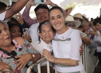 President Sheinbaum hugs a constituent at a packed rally