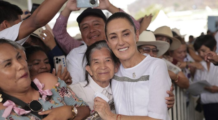 President Sheinbaum hugs a constituent at a packed rally