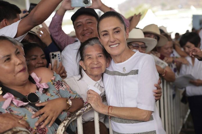 President Sheinbaum hugs a constituent at a packed rally