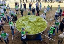 A giant vat of guacamole weighing 7.2 tonnes with volunteers scattered around it