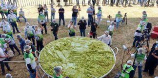 A giant vat of guacamole weighing 7.2 tonnes with volunteers scattered around it