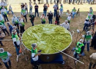 A giant vat of guacamole weighing 7.2 tonnes with volunteers scattered around it