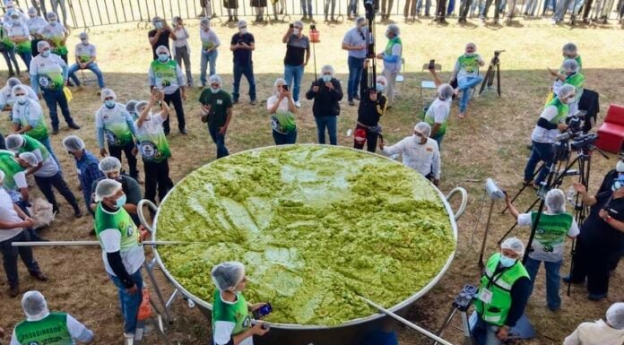 A giant vat of guacamole weighing 7.2 tonnes with volunteers scattered around it