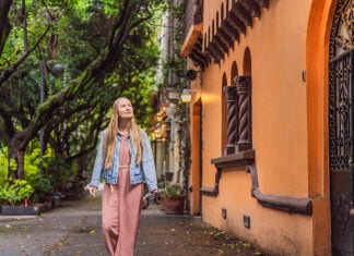 A white woman strolls the streets of Condesa in Mexico City