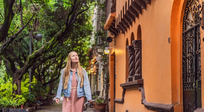 A white woman strolls the streets of Condesa in Mexico City
