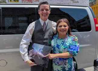Mexico City Mayor Clara Brugada and actor Pedro Pascal pose with an axolotl figurine