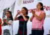 President Claudia Sheinbaum makes a heart with her hands, flanked by Guerrero Gov. Evelyn Salgado and former Welfare Minister Ariadna Montiel