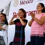 President Claudia Sheinbaum makes a heart with her hands, flanked by Guerrero Gov. Evelyn Salgado and former Welfare Minister Ariadna Montiel
