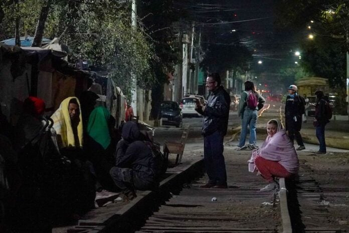 migrants outside at dark
