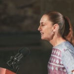 President Sheinbaum speaks into a microphone