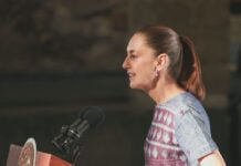 President Sheinbaum speaks into a microphone
