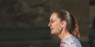 President Sheinbaum speaks into a microphone