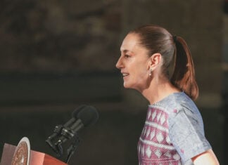 President Sheinbaum speaks into a microphone