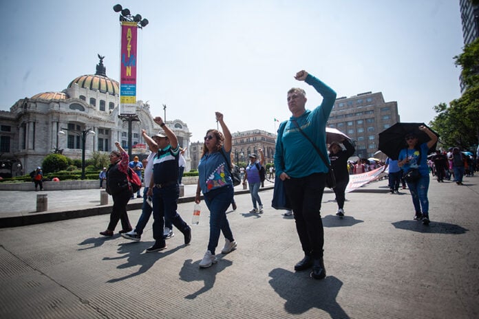 Members of the CNTE teachers union march past Mexico City's Palacio de Bellas Artes on Tuesday.