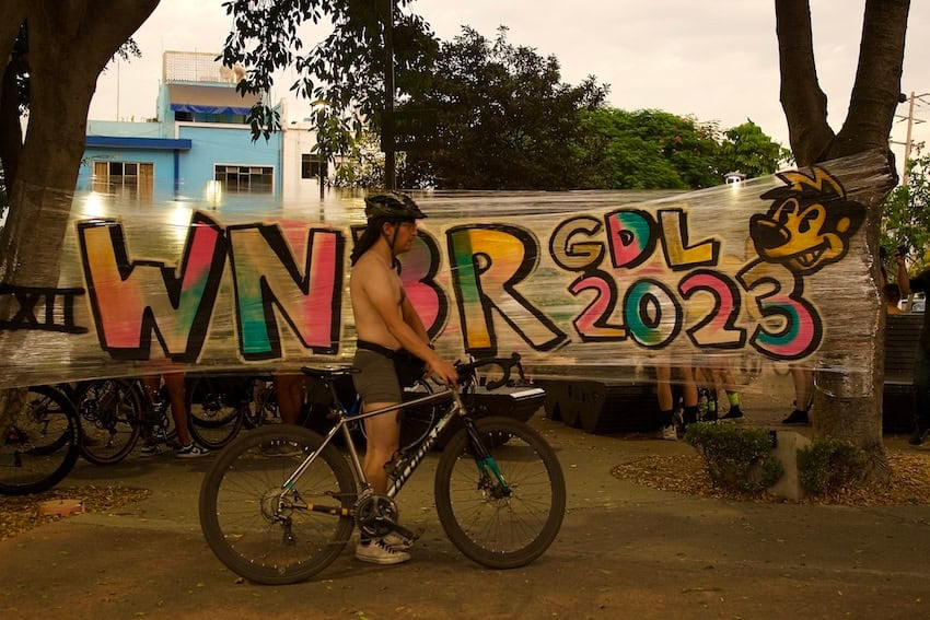 A man riding a bicycle in his underwear