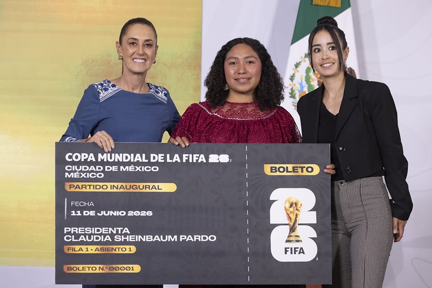 President Sheinbaum poses with juggling contest winner Yolett Cervantes and a giant World Cup ticket