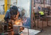 A welder works in a metal shop in Mexico