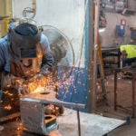 A welder works in a metal shop in Mexico
