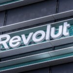 Revolut logo signboard on modern office building in Vilnius, Lithuania on May 30, 2021. Revolut is financial technology company that offers banking services
