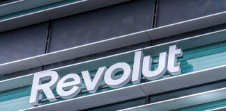 Revolut logo signboard on modern office building in Vilnius, Lithuania on May 30, 2021. Revolut is financial technology company that offers banking services