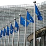 European Union Flags Waving In Brussels Opposite The European Commission Building
