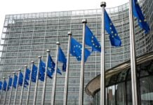 European Union Flags Waving In Brussels Opposite The European Commission Building